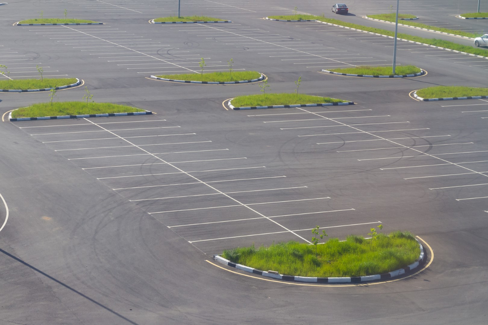 New car parking with markings, lawn and new asphalt, top view.